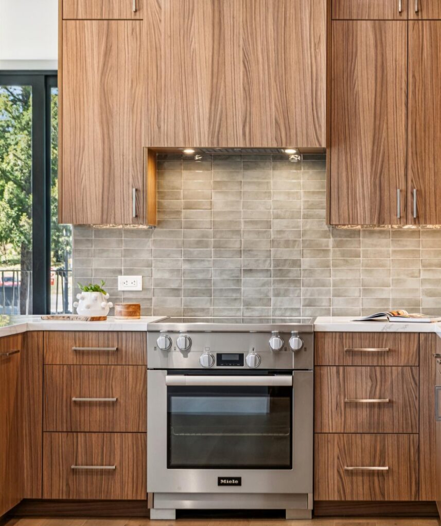 Couple in a Nova kitchen with Miele appliances and quartz countertops, enjoying low-maintenance downsizing in Danville