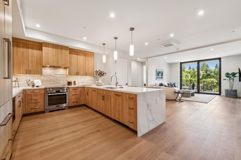 Couple cooking together in a Nova kitchen with Miele appliances and quartz countertops, enjoying low-maintenance downsizing in Danville